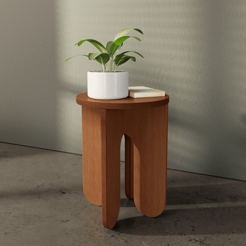 Stained Walnut side table with a plant and a book on top in modern interior setting.