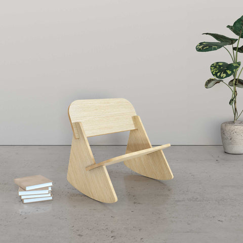 Mini Rocker Assembly of a wooden kids rocking chair next to stacked books and a plant.