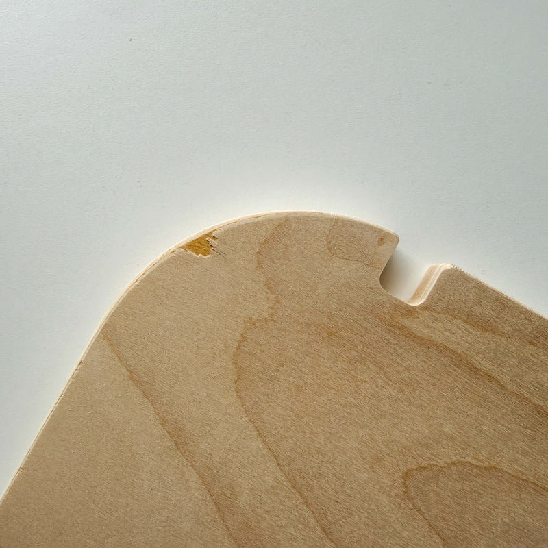 Close-up of blemished wood furniture showing scratches and natural imperfections, highlighting its unique character.