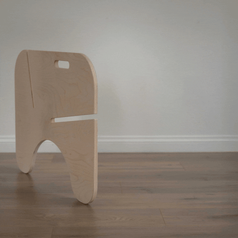 Modern wooden stool design on hardwood floor, showcasing minimalist aesthetics and functionality.