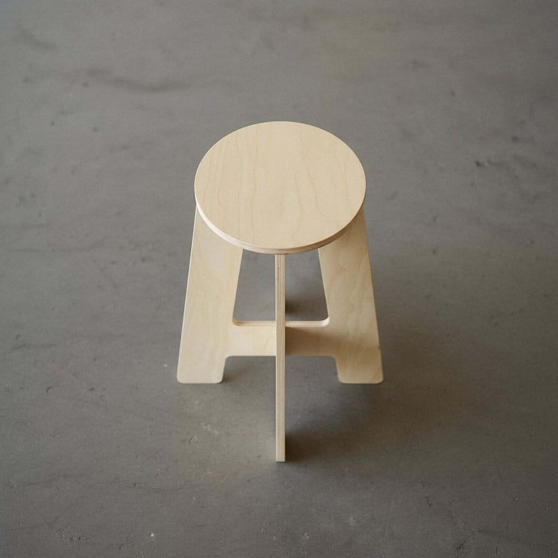 A-Stool made of birch plywood with clean lines and a simple design, perfect for sitting or counter use.