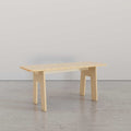 Sleek Modern Bench in light wood, showcasing minimalist design and sturdy legs, ideal for any modern living space.