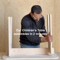 Adult assembling a kids table showcasing quick and easy setup for children's furniture in just 2 minutes.
