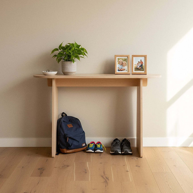 Modern Console Table with plant, photos, backpack, and shoes in a bright entryway.