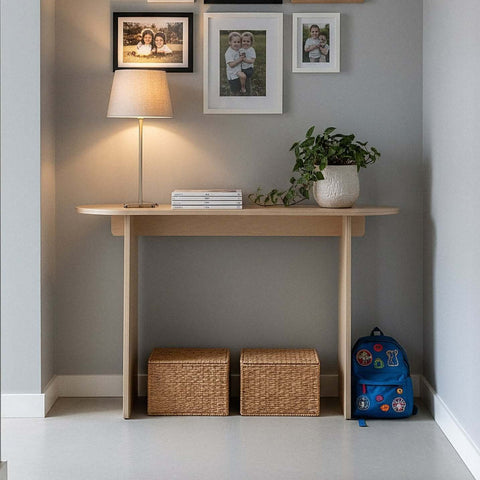 Modern Console Table in stylish entryway with lamp, photos, and decorative plants.