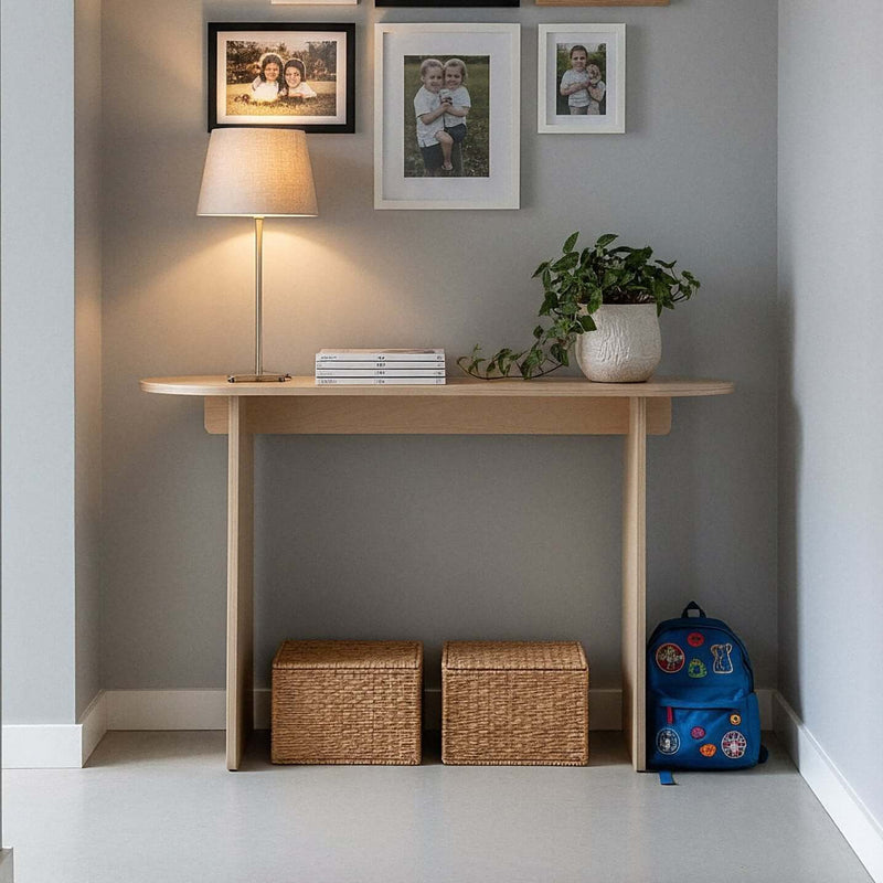 Modern Console Table in stylish entryway with lamp, photos, and decorative plants.