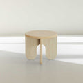 Blemished round wooden side table with unique leg design and subtle imperfections.