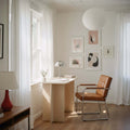 Modern Desk in a bright, minimalist room with natural light and simple décor.