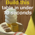 Unfinished side table with decorative objects, highlighting easy assembly in under 10 seconds.