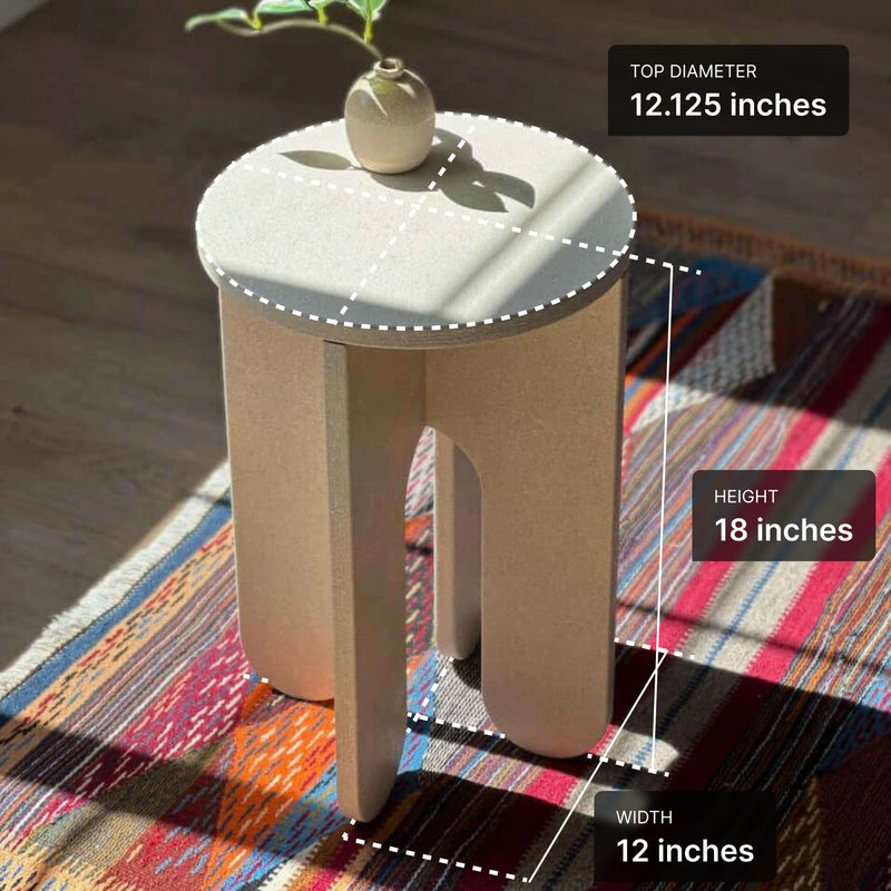 Minimalist beige side table with measurements on a colorful rug, showcasing dimensions of 12.125" diameter and 18" height.