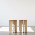Side Table - Modern unfinished wooden side tables that can be customized for various uses in stylish spaces.