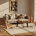Round Coffee Table styled in a cozy living room with beige sofa, candles, and artistic decor.